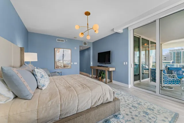 a living room with furniture a large window and a flat screen tv