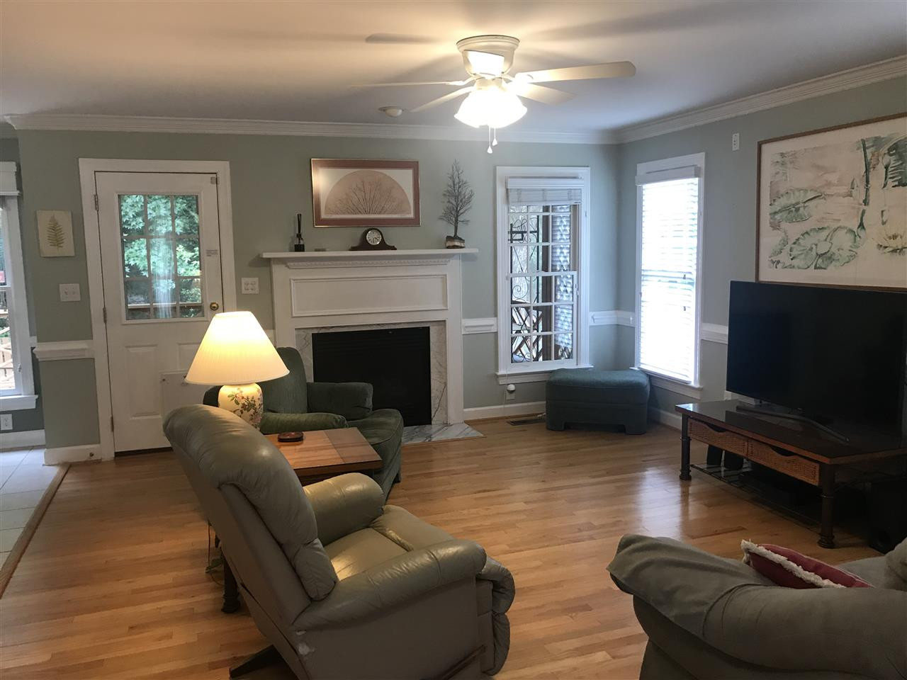 2900 Dahlgreen Road Raleigh, NC 27615 - Photo 2 of 25 Family room with hardwood floors, fireplace with gas logs and new ceiling fan. Opens to kitchen and breakfast room with door onto screened porch. Family Room