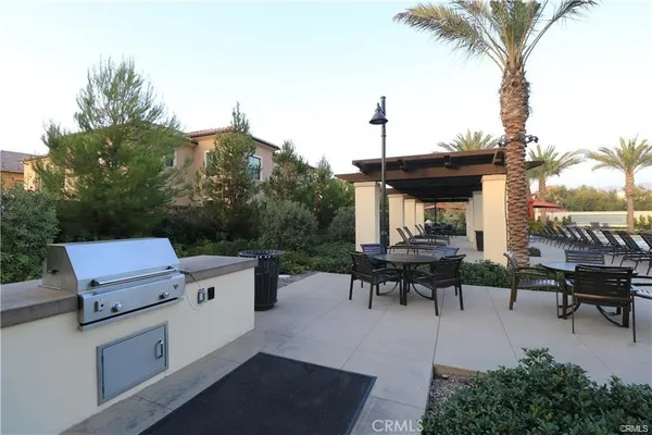 a backyard of a house with table and chairs