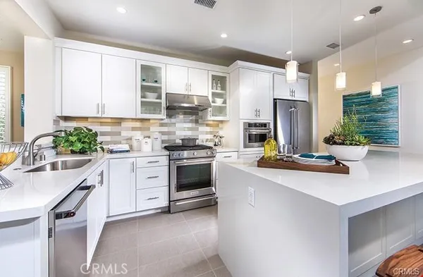 a kitchen with a sink stove and refrigerator