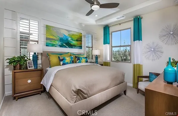 a bed sitting in a bedroom next to a window