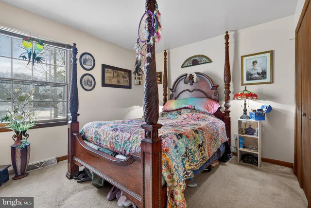 a bedroom with bed and a window