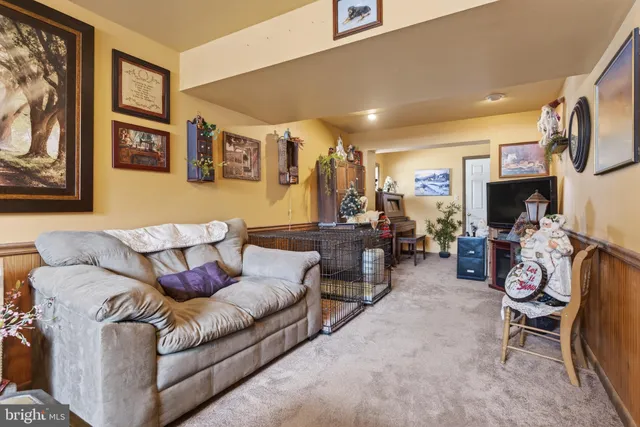 a living room with furniture a flat screen tv and a table