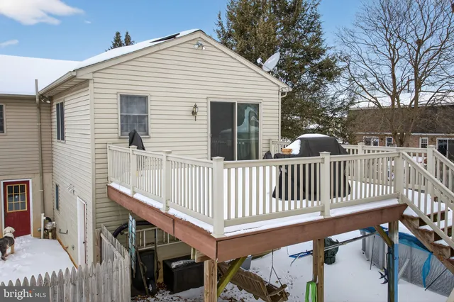 a view of a house with wooden deck