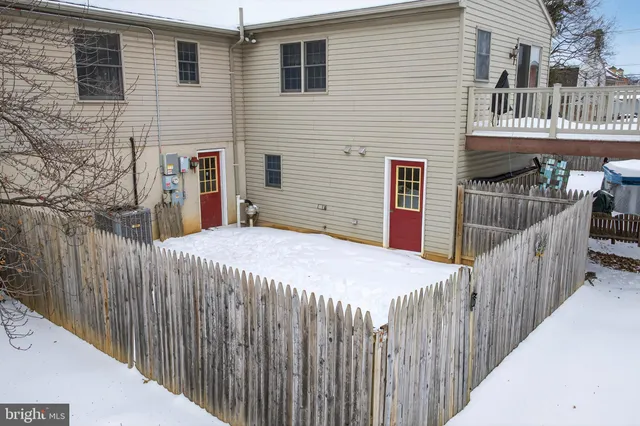 a view of a house with wooden fence