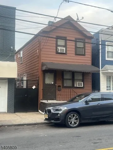 a front view of a house with parking space
