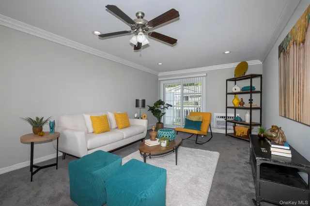 a living room with furniture and a book shelf