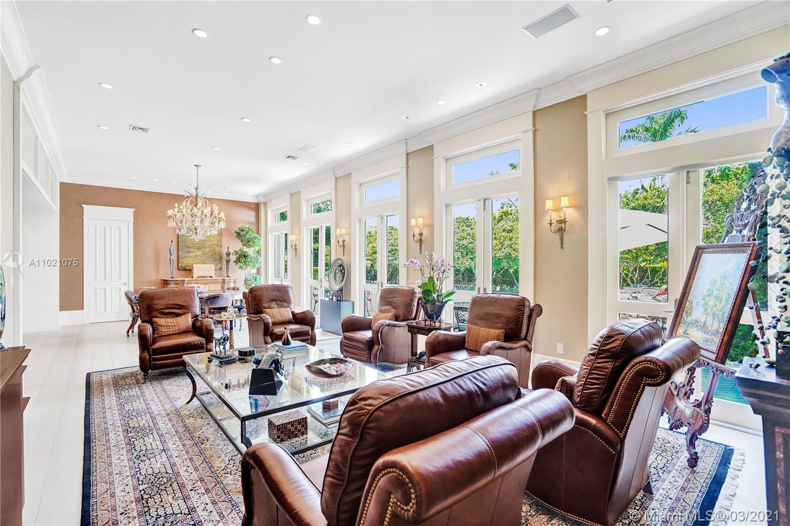 3014 Pine Tree Drive Miami Beach, FL 33140 - Photo 12 of 43 a living room with furniture large windows and outdoor view