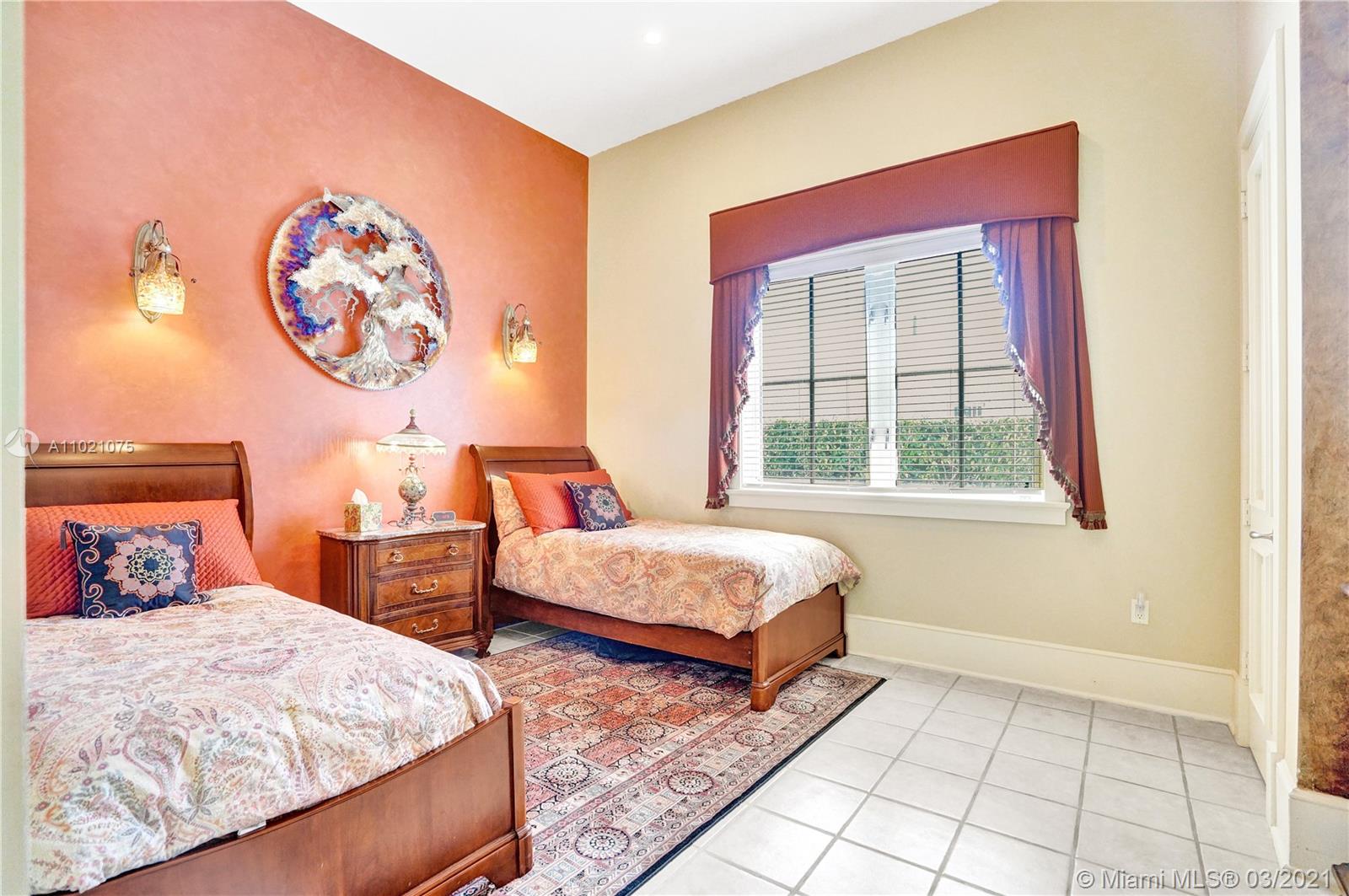 3014 Pine Tree Drive Miami Beach, FL 33140 - Photo 17 of 43 a bedroom with 2 bed and a window