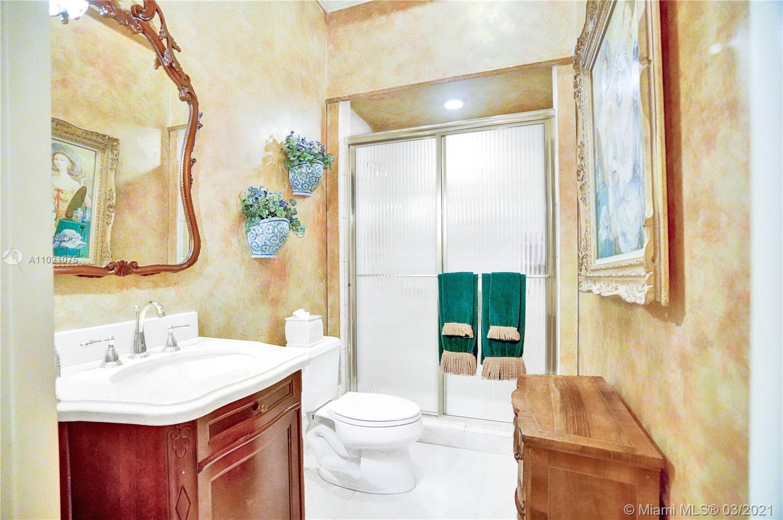 3014 Pine Tree Drive Miami Beach, FL 33140 - Photo 18 of 43 a bathroom with a sink vanity mirror and toilet