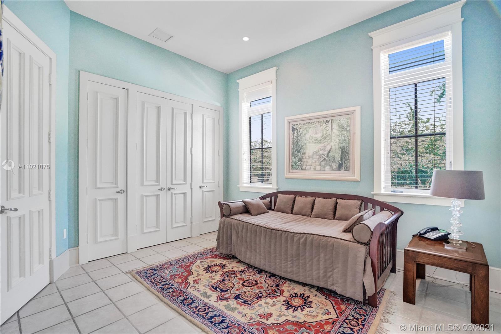 3014 Pine Tree Drive Miami Beach, FL 33140 - Photo 19 of 43 a living room with furniture and a rug