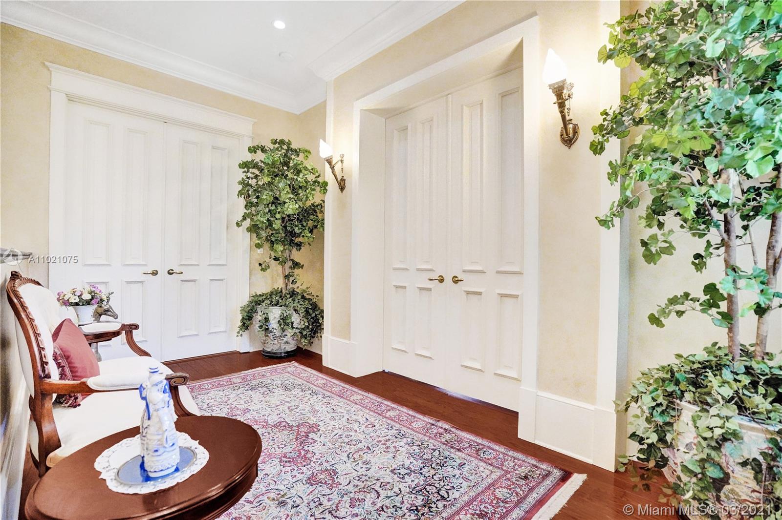 3014 Pine Tree Drive Miami Beach, FL 33140 - Photo 23 of 43 a living room with furniture and a potted plant
