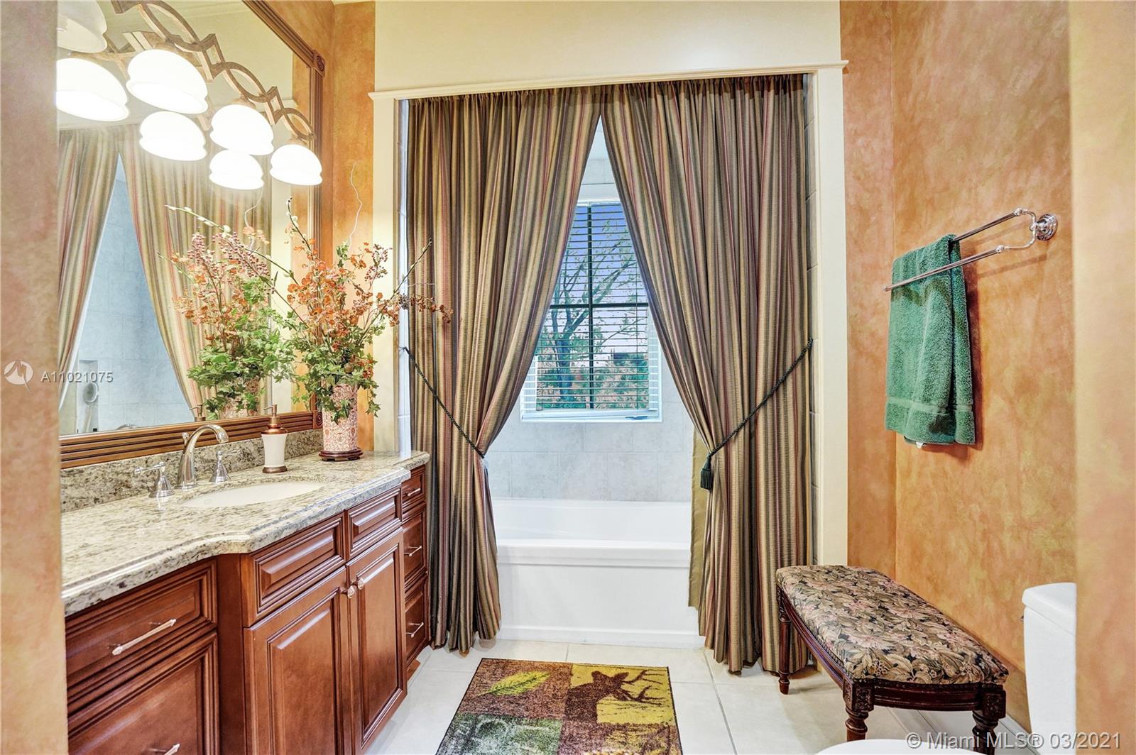 3014 Pine Tree Drive Miami Beach, FL 33140 - Photo 25 of 43 a bathroom with a granite countertop sink and a mirror