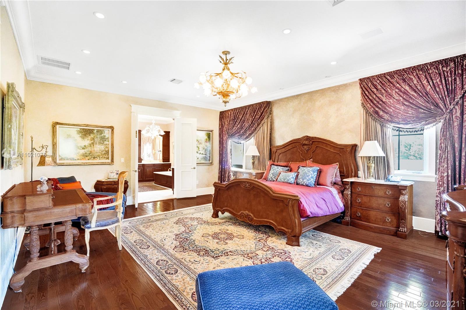 3014 Pine Tree Drive Miami Beach, FL 33140 - Photo 29 of 43 a bedroom with a bed and wooden floor