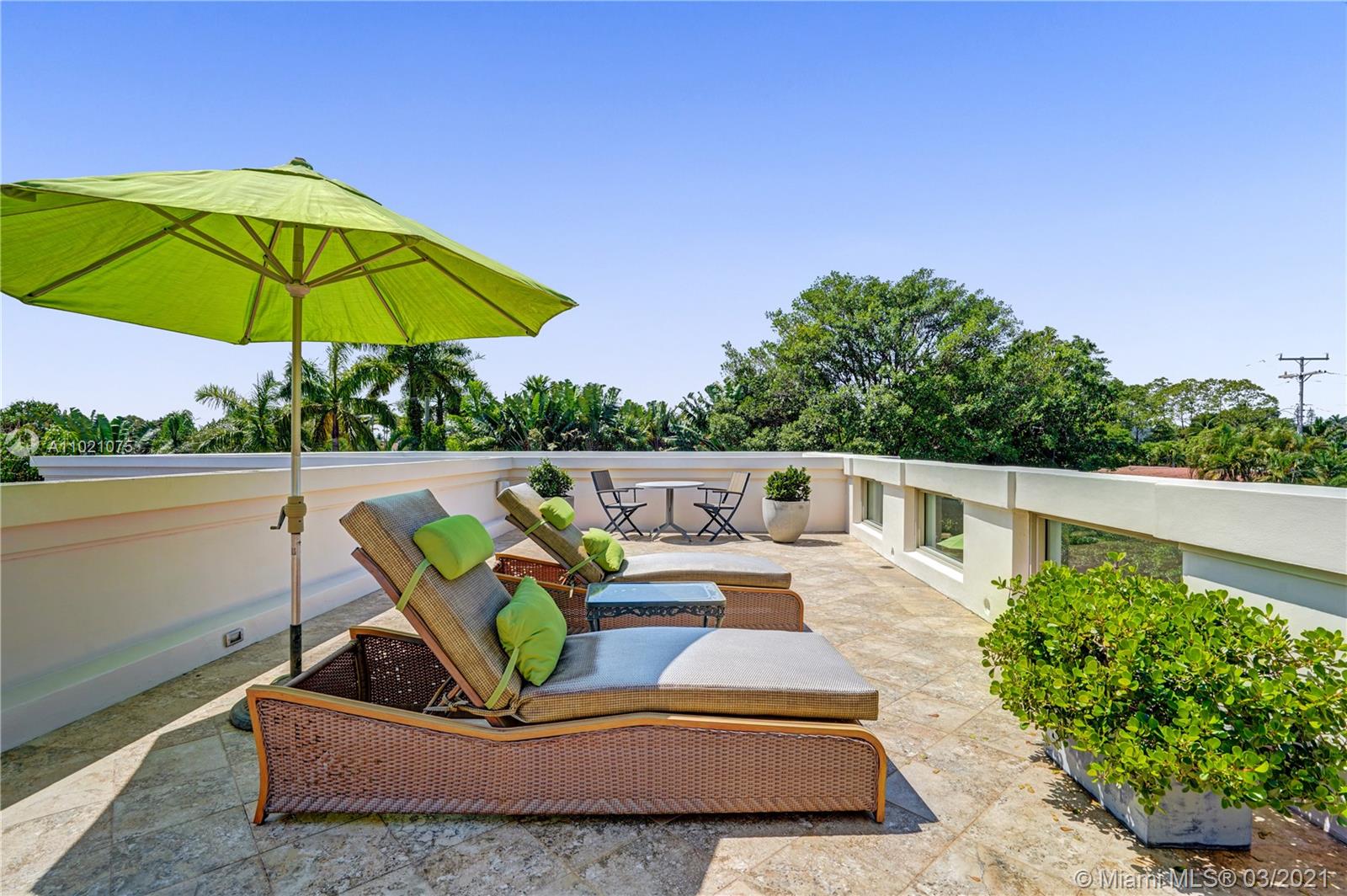 3014 Pine Tree Drive Miami Beach, FL 33140 - Photo 32 of 43 a view of a patio with a table and chairs under an umbrella