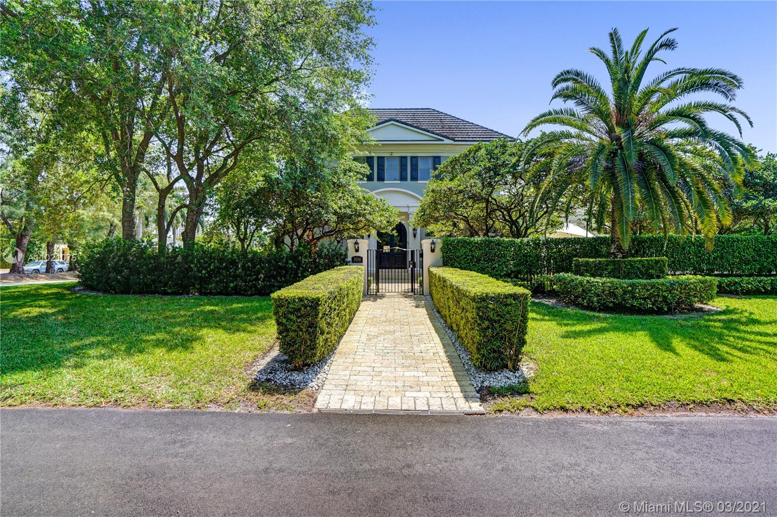 3014 Pine Tree Drive Miami Beach, FL 33140 - Photo 34 of 43 a view of a garden with a fountain