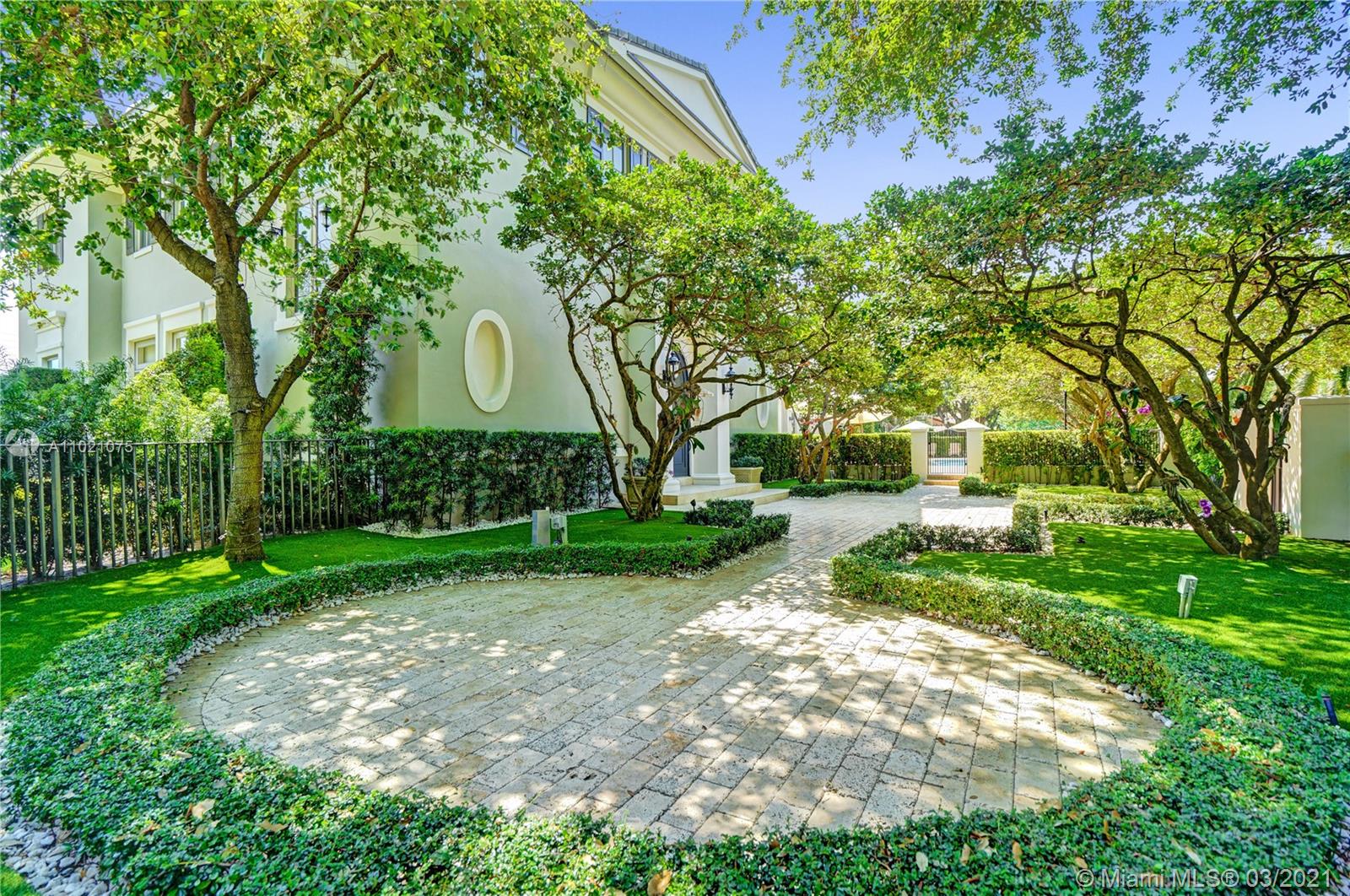 3014 Pine Tree Drive Miami Beach, FL 33140 - Photo 37 of 43 a front view of a house with garden