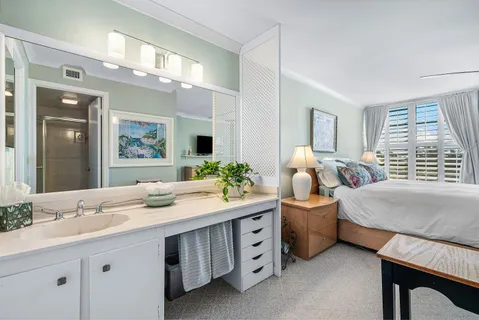 a bathroom with a shower sink vanity mirror and toilet