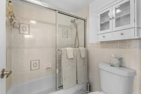 a view of a house with a yard and potted plants