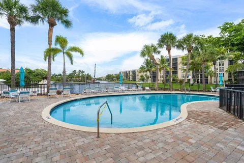 an aerial view of residential houses with outdoor space and swimming pool
