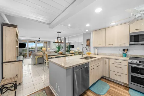 a kitchen with stainless steel appliances a refrigerator sink and microwave
