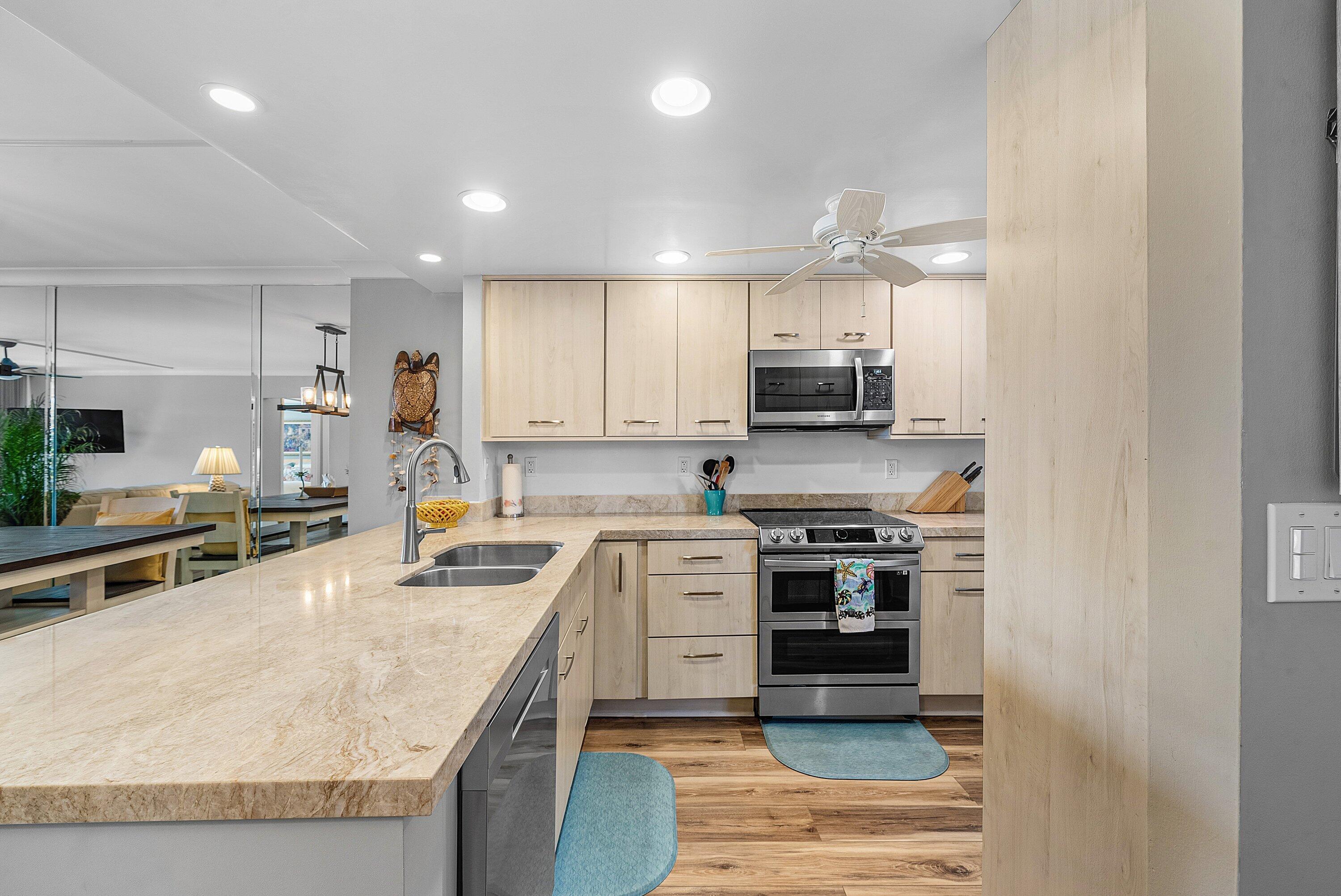 7 Royal Palm Way, Unit 507 Boca Raton, FL 33432 - Photo 7 of 47 a kitchen with a stove a sink and a microwave