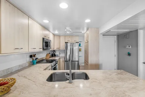 a kitchen with a stove a kitchen island a table and chairs in it