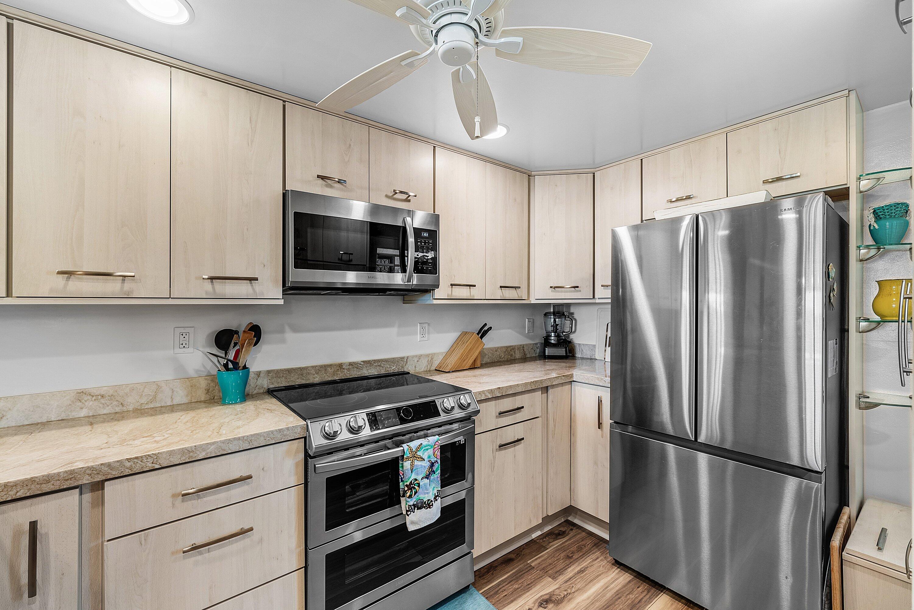 7 Royal Palm Way, Unit 507 Boca Raton, FL 33432 - Photo 10 of 47 a kitchen with stainless steel appliances a refrigerator sink and microwave
