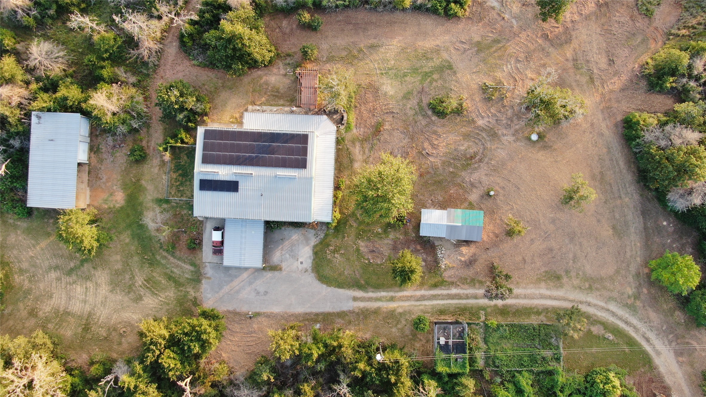1004 22 Hills Road Gause, TX 77857 - Photo 23 of 37 An aerial perspective reveals multiple structures nestled amidst verdant natural landscaping.