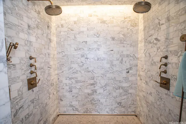 a bathroom with a granite countertop sink and a window