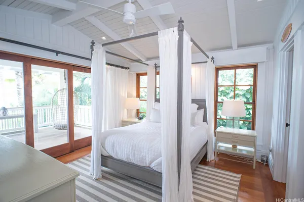 a bedroom with a bed and window with lamp