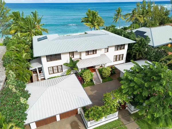 an aerial view of a house with porch and furniture