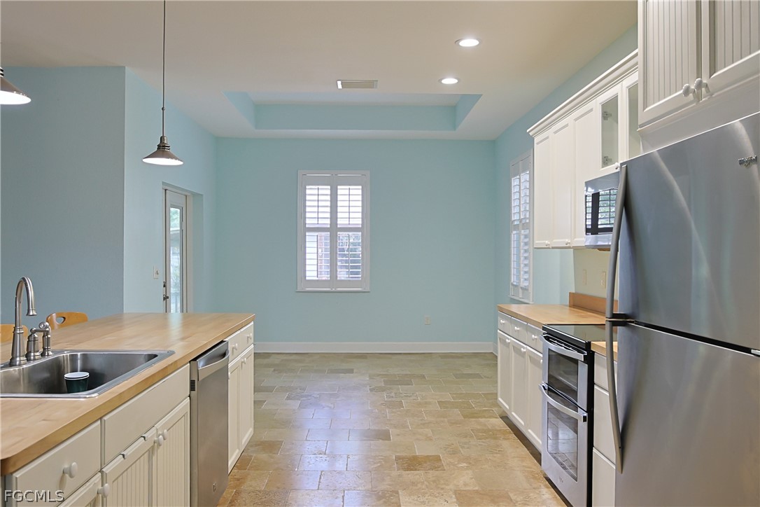 21531 Pearl Street Alva, FL 33920 - Photo 11 of 41 a kitchen with a refrigerator and a sink