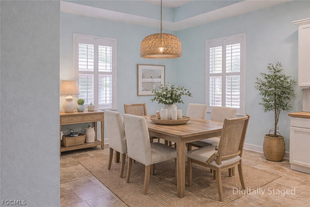 21531 Pearl Street Alva, FL 33920 - Photo 12 of 41 a dining room with furniture potted plants and a chandelier