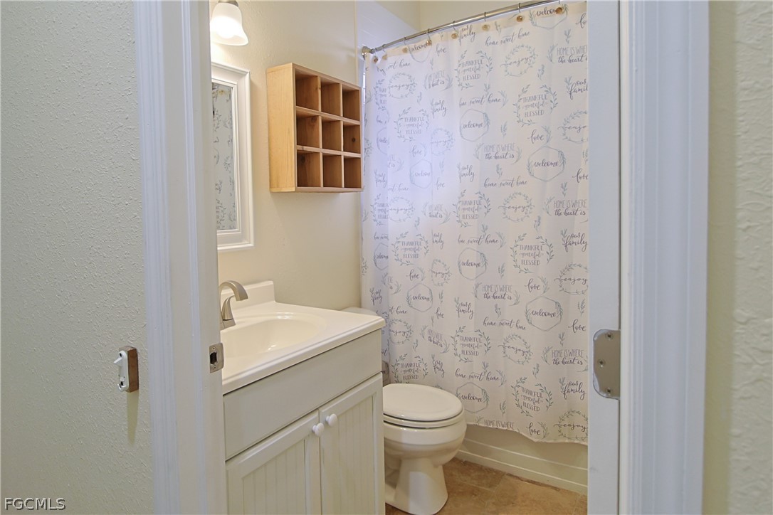 21531 Pearl Street Alva, FL 33920 - Photo 21 of 41 a bathroom with a sink a toilet and shower