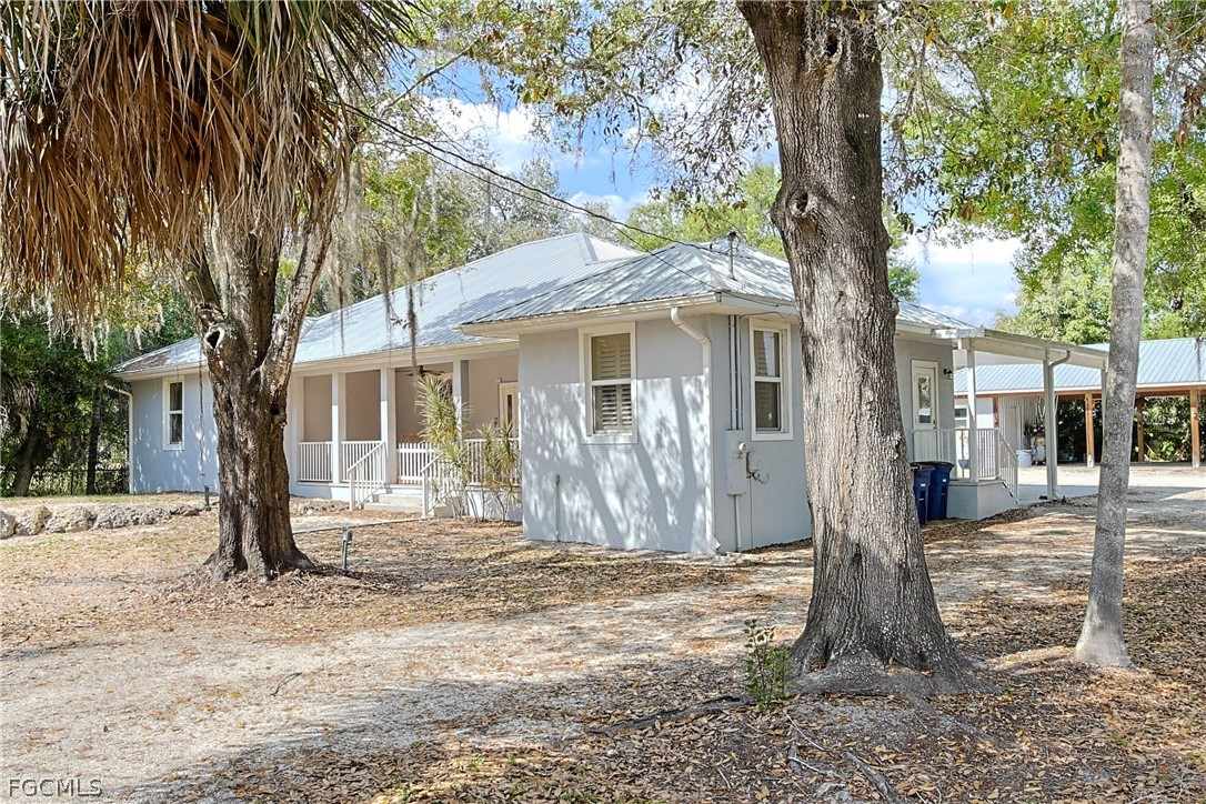 21531 Pearl Street Alva, FL 33920 - Photo 3 of 41 a view of a house with a tree in the yard