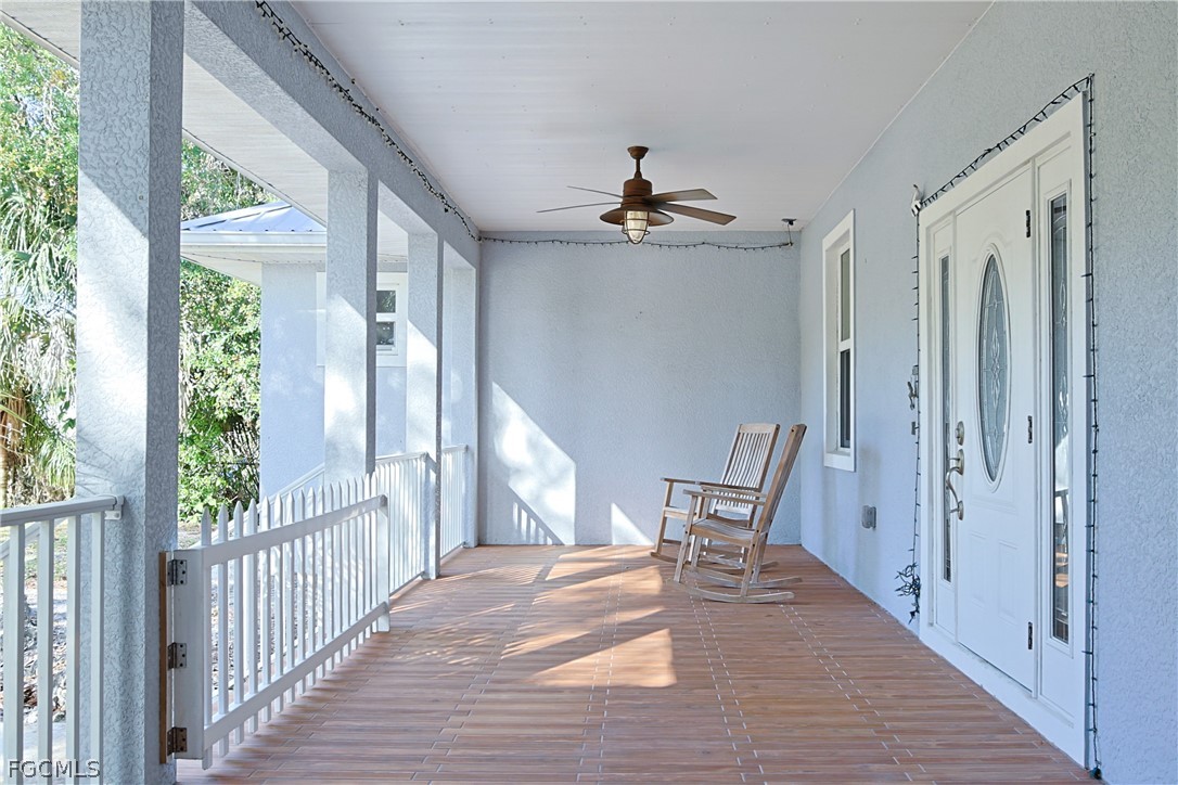 21531 Pearl Street Alva, FL 33920 - Photo 5 of 41 a view of a hallway with wooden floor and windows