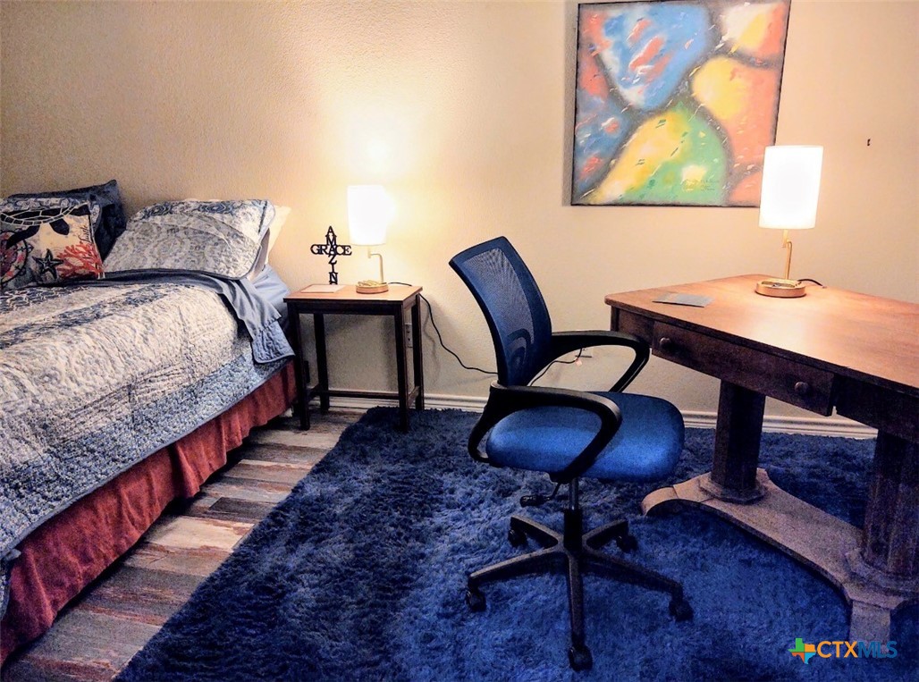 130 Sobrante Road, Unit 209 Belton, TX 76513 - Photo 14 of 36 a bedroom with bed and a workspace