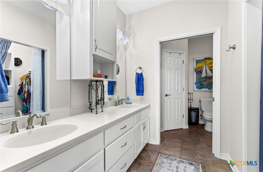 130 Sobrante Road, Unit 209 Belton, TX 76513 - Photo 17 of 36 a bathroom with a double vanity sink and a mirror