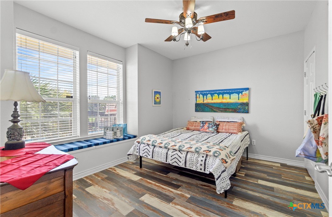 130 Sobrante Road, Unit 209 Belton, TX 76513 - Photo 19 of 36 a bedroom with a bed and a chandelier