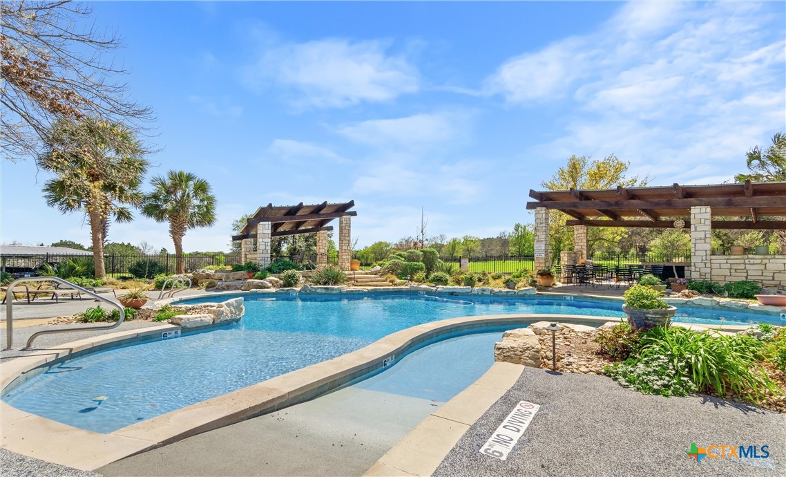 130 Sobrante Road, Unit 209 Belton, TX 76513 - Photo 3 of 36 a view of a swimming pool and lounge chair