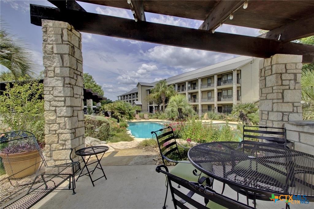 130 Sobrante Road, Unit 209 Belton, TX 76513 - Photo 33 of 36 a view of a backyard with table and chairs and potted plants