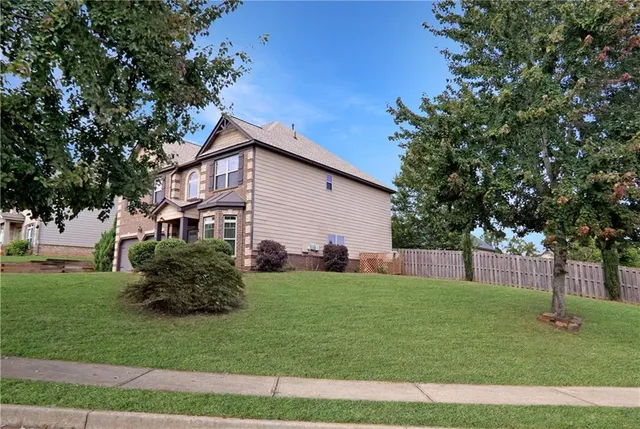 a front view of a house with a garden
