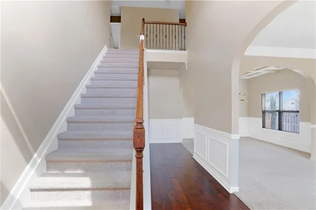 a view of staircase with white walls and a window
