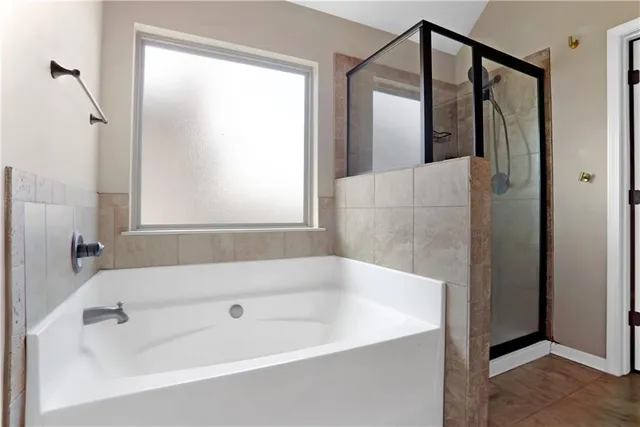a bathroom with a bathtub and a shower