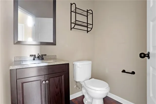 a bathroom with a toilet sink and mirror