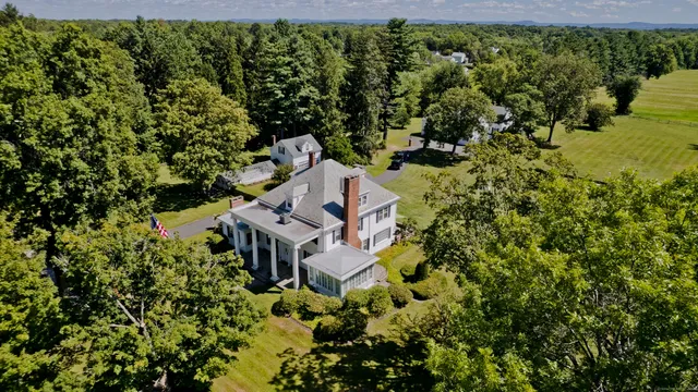 an aerial view of a house with a yard basket ball court and outdoor seating