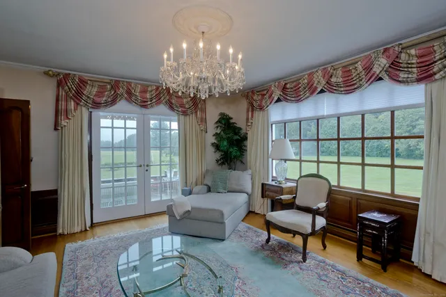 a living room with furniture and a chandelier