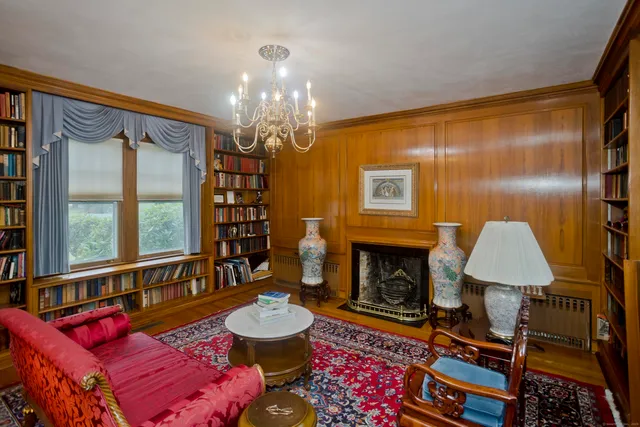 a living room with furniture fireplace and a large window