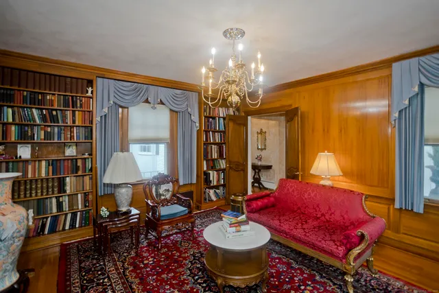 a living room with furniture a lamp and a chandelier